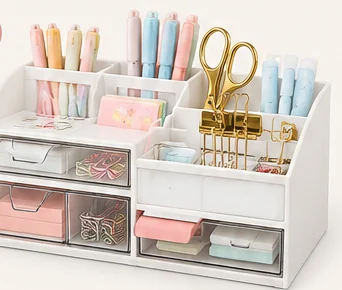 White gianotter desk organizer with pen cups, drawers, and compartments holding pens and clips